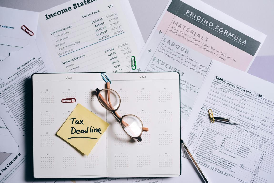 Tax documents and reading glasses on a desk